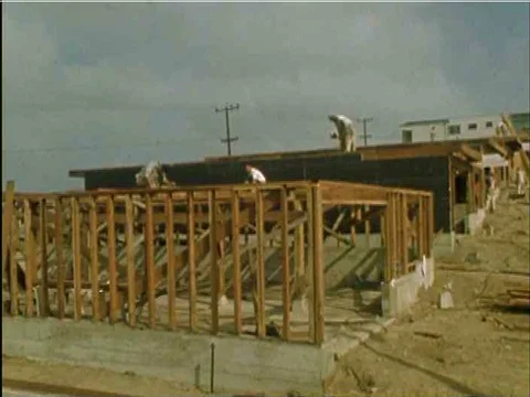 Construction workers hammer nails, use a trowel on a wall and pour a foundation, Stock Footage 74966524