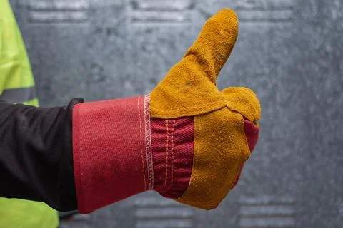 Construction worker's hand in orange and red leather protective work glove .. Stock Photos