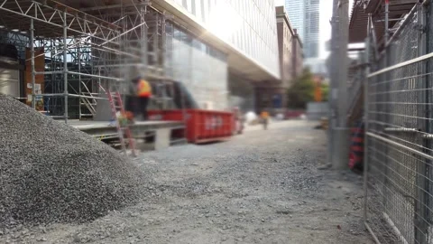 Construction workers in hard hats and safety uniforms discard debris Stock Footage 346368456