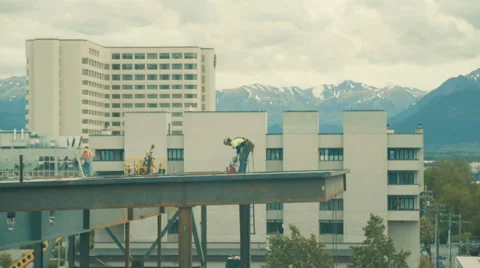 Construction workers high up on scaffolding Stock Footage 67386258