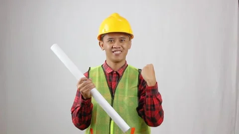 Construction workers holding blueprints enthusiastically Stock Footage 319923688
