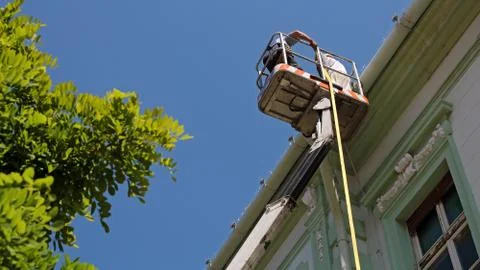 Construction Workers on Hydraulic Platform Stock Photos