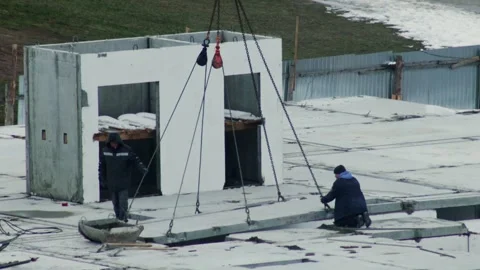 Construction workers install concrete floor slab onto unfinished building Stock Footage 344864543