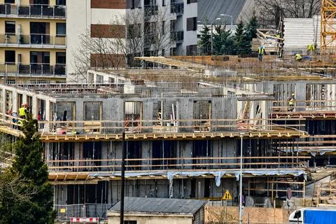 Construction workers install formwork and iron rebars or reinforcing bars for Stock Photos
