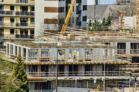 Construction workers install formwork and iron rebars or reinforcing bars for Stock Photos