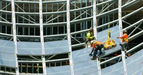 Construction workers install glass windows at development site 4K RAW Stock Footage 66955724