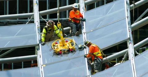Construction workers install glass windows at development site, 4K, RAW Stock Footage 66968165