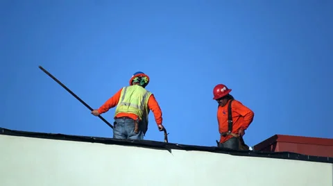 Construction workers install the roof at development site 스톡 동영상 33896686