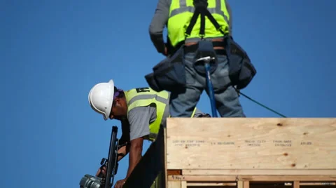Construction workers install the roof at development site 스톡 동영상 34084796