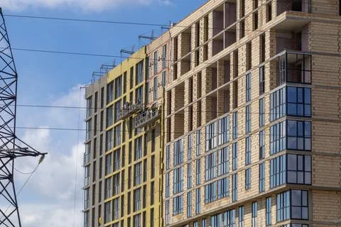 Construction Workers Install Windows on a Building in a City Under a Clear .. Stock Photos