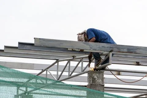 A construction workers installing beam formwork. Formwork is located at the h Stock Photos