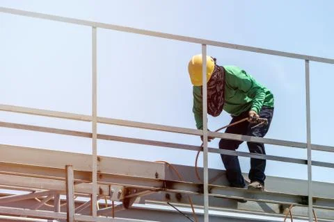 A construction workers installing beam formwork. Formwork is located at the h Stock Photos