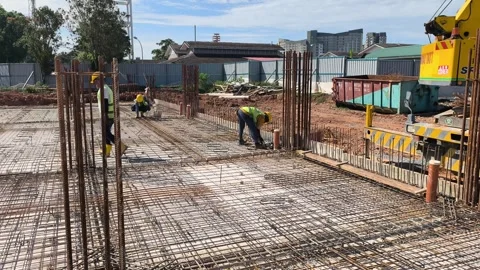 Construction Workers Installing BRC Steel Mesh for Reinforced Concrete Floor Stock Footage 336644544