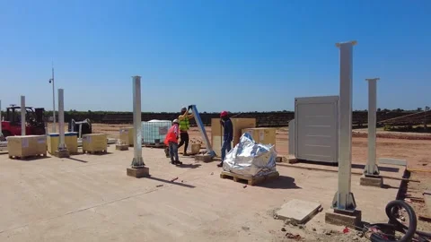 Construction workers installing inverter station at utility scale solar farm Stock Footage 343010235