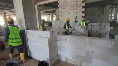 Construction Workers Installing Lightweight AAC Blocks for Wall Building Stock Footage 334720009