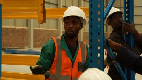 Construction workers installing racks and shelfs in warehouse Stock-Footage 143777788