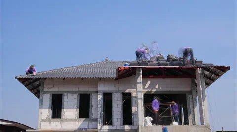 Construction workers installing roof tiles for home building Stock Footage 60051841