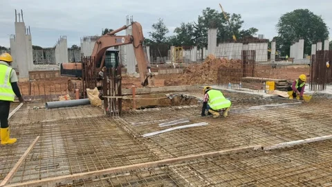 Construction Workers Installing Steel Rebar for Concrete Floor Slab Stock Footage 333498389