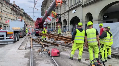 Construction workers installing tram lines in the city, street under Stock Footage 335132361