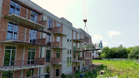 Construction Workers Installing Windows from Lift Platform, Facade assembly on Stock Footage 312169266
