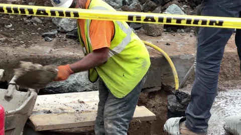 Construction workers on job site jackhammer concrete road New York City street 스톡 동영상 162593363