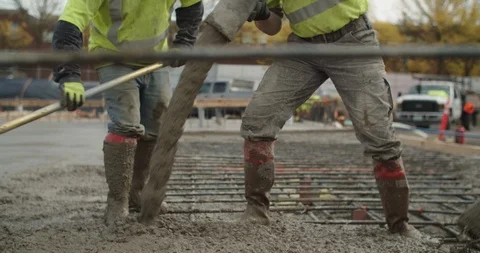 Construction workers laying a concrete foundation Stock Footage 117183690