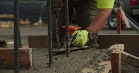 Construction workers laying a concrete foundation Stock Footage 117183819