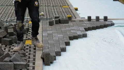 Construction workers laying interlocking paving concrete Stock Footage 90566512