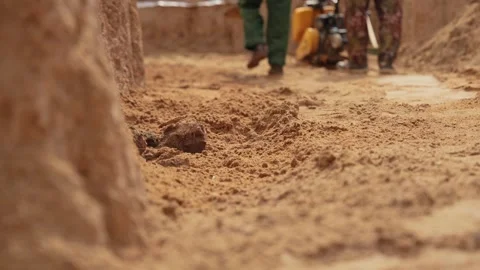 Construction workers leveling sand on a building site Stock Footage 341294846