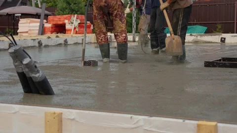 Construction workers leveling wet concrete foundation Stock Footage 341294425