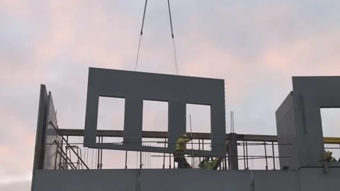 Construction workers lifting a concrete panel at a building site Stock Footage 302006125