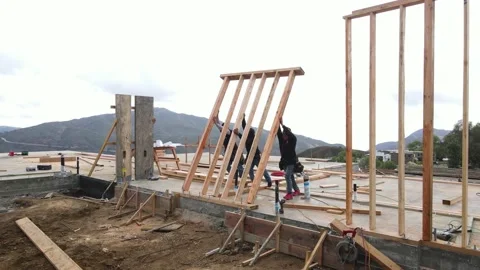 Construction workers lifting up wall for house Stock-Footage 228794814