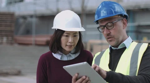 Construction workers looking at project development Stock Footage 64200599