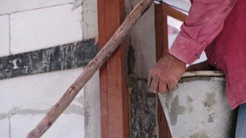Construction workers man using containers to pour mixed cement into buildin.. Stock Footage 300082062