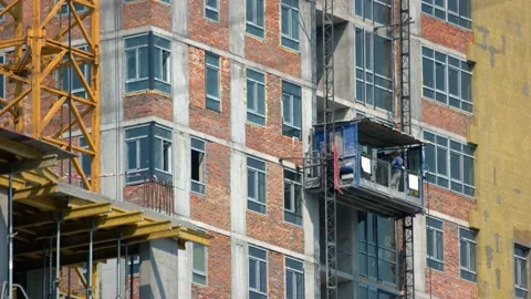 Construction workers moving down on the elevator. Stock Footage 194926652