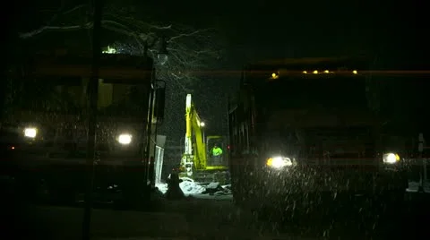 Construction workers at night in the snow Stock Footage 17049876