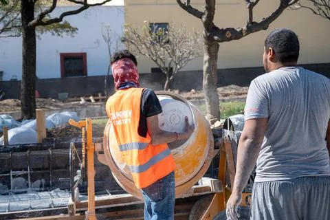 Construction workers operating cement mixer on building site in Zapopan, Mexico Stock Photos