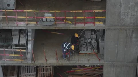 Construction workers operating jackhammer on concrete floor Stock Footage 333496671