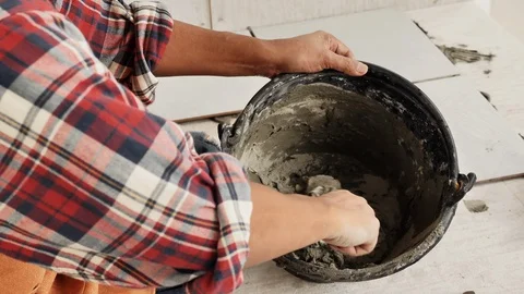 Construction workers or technicians is mixing the cement in the bucket Stock Footage 128601728