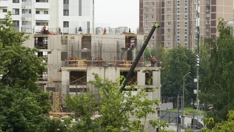 Construction workers in orange hardhats building concrete high-rise summer day. Stock Footage 330217665