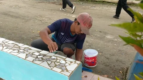 Construction workers painting garden seating Stock Footage 262539165