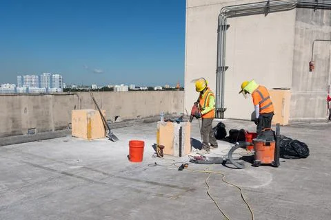 Construction workers in parking lot. Stock Photos