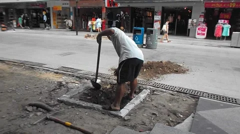 Construction workers in the pavement construction, excavation pit Stock Footage 67744459