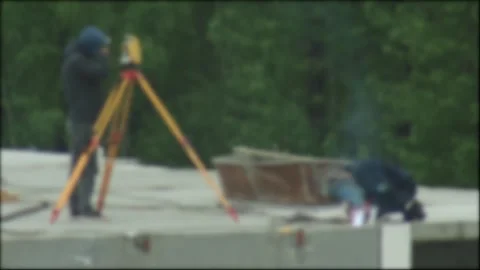 Construction workers performing land survey and welding work on building Stock Footage 335763155
