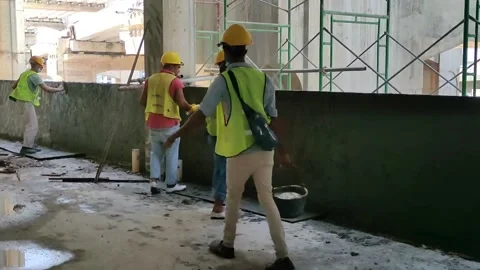 Construction workers performing wall plastering on a concrete wall Stock Footage 306755514