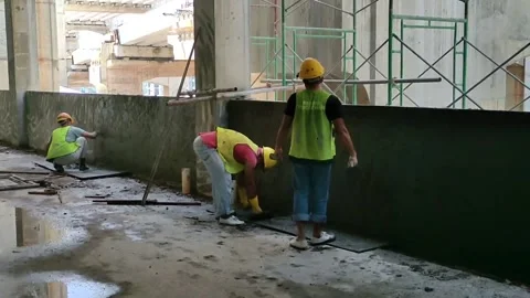 Construction workers performing wall plastering on a concrete wall Video stock 306755624