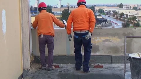 Construction workers place a plastic reinforcing mesh under the plaster morta Stock-Footage 300497220