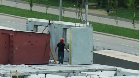 Construction Workers Position Prefabricated Panel. Building Team Assembles Stockbeeldmateriaal 322094898