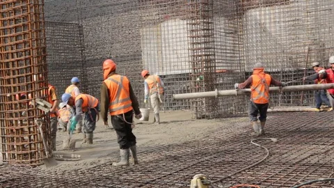 Construction workers pour concrete Stock Footage 77100845