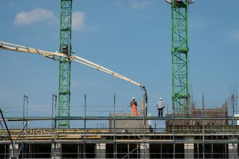 Construction workers pour concrete Stock Photos